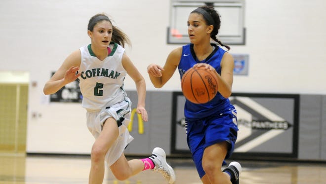 Zanesville's Destiny Johnson drives past Dublin Coffman's Jacy Sheldon during the Lady Devils' 47-34 loss in the Division I District semifinals Wednesday in Pickerington.