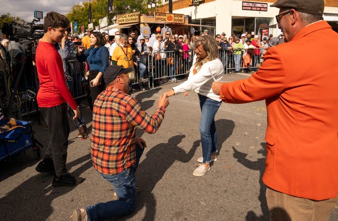 Oct 18, 2023; Circleville, OH, USA; Chris Wheeler proposes to Holly Dailello while Wheelers pumpkins are weighed in during the Pumpkin Show. Dailello said yes.