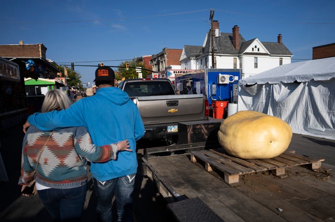 Oct 18, 2023; Circleville, OH, USA; People walk the fairway where pumpkins are waiting to be weighed during the Circleville Pumpkin Show.