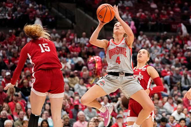 Feb 14, 2024; Columbus, Ohio, USA; Ohio State Buckeyes guard Jacy Sheldon (4) shoots around Nebraska Cornhuskers guard Kendall Moriarty (15) during the first half of the NCAA women’s basketball game at Value City Arena.