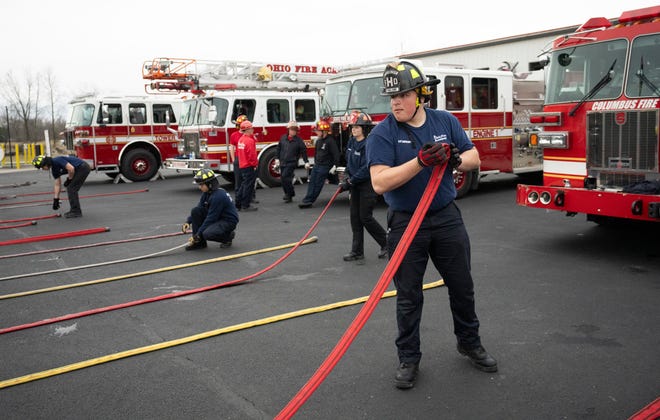 Feb 27, 2024; Reynoldsburg, OH, United States; Jakob Baxter gathers a firehose after training in a technique on how to handle the hose after use during a training session at the Division of State Fire Marshal's Ohio Fire Academy. Baxter is learning the techniques in order to work as a volunteer firefighter.