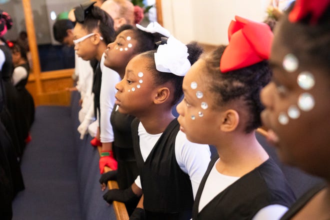 Mar 24, 2024; Columbus, OH; Dancers with the Butterflies and OSAO (Our Steps Are Ordered) Dance Ministry listen to the actors during an Easter performance at the Family Missionary Baptist Church on Palm Sunday.