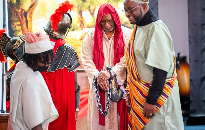 Mar 24, 2024; Columbus, OH; Revered Fred Booker dressed as Jesus is arrested in handcuffs during an Easter performance at the Family Missionary Baptist Church on Palm Sunday. The performance reenacted several scenes from the crucifixion, last dinner and resurrection of Jesus.
