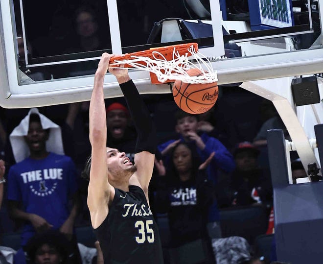 Lutheran East's Jesse McCulloch (35) dunks the ball during his team's win over Harvest Prep in the Division III state championship game Sunday, March 24, 2024.
