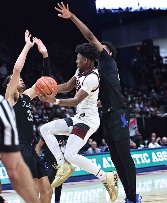 Harvest Prep guard Brandon Roddy (10) drives to the basket against Lutheran East players Jesse McCulloch (35) and Ronald Taylor during the Division III state championship game Sunday, March 24, 2024.