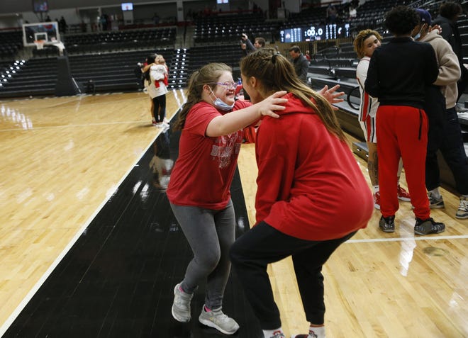 Emmy Sheldon, 14, hugs her sister Ohio State Buckeyes guard Jacy Sheldon (4) after the NCAA women’s basketball game between Ohio State University at the University of Cincinnati in Columbus, Ohio, on Saturday, Nov. 27, 2021.