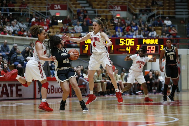 Ohio State Buckeyes guard Madison Greene (0) and Ohio State Buckeyes guard Jacy Sheldon (4) both attempt to foul Purdue Boilermakers guard Kayana Traylor (23) to stop the clock with only a few minutes left of the game between the Ohio State Buckeyes and the Purdue Boilermakers at St. John Arena in Columbus, Ohio Saturday, Dec. 28, 2019. [Maddie Schroeder/Dispatch]