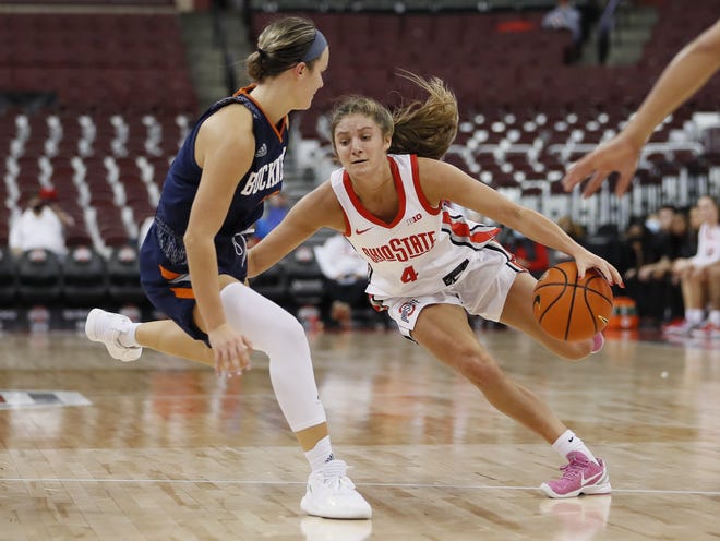 Ohio State Buckeyes guard Jacy Sheldon (4) changes direction as she dribbles past Bucknell Bison guard Marly Walls (12) during the second quarter of the NCAA women's basketball game at Value City Arena in Columbus on Wednesday, Nov. 10, 2021.