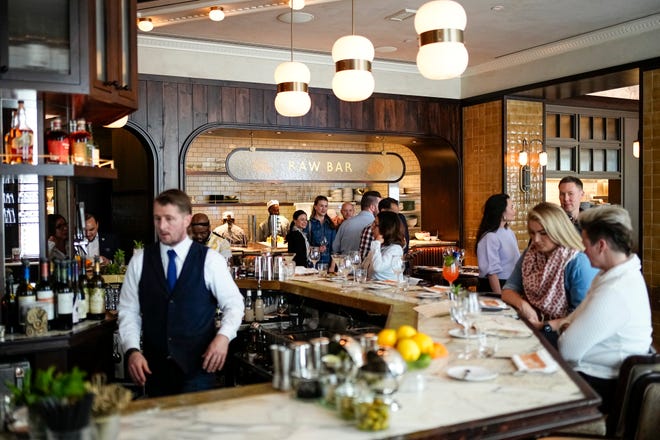 Guests enjoy the grand-opening event for Hank’s Low Country Seafood & Raw Bar on April 23.