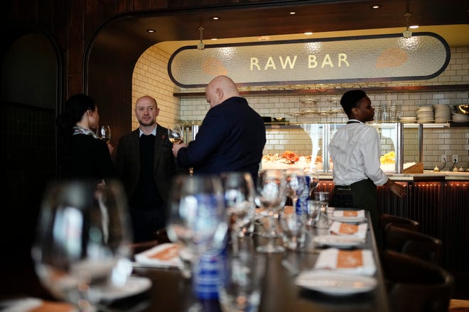Apr 23, 2024; Columbus, OH, USA; Guests enjoy the grand opening event for Hank’s Low Country Seafood & Raw Bar at the corner of Gay and High downtown. Hank’s, which opened its first restaurant in Charleston, S.C., includes a lounge, expansive bar, dining room, raw bar and private dining room.