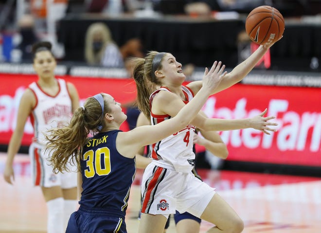 Ohio State Buckeyes guard Jacy Sheldon (4) drives to the basket around Michigan Wolverines guard Elise Stuck (30) during the second quarter of the women's college basketball game at Value City Arena in Columbus on Thursday, Jan. 21, 2021.